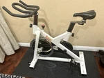 Sunny SF-B1110 Upright Exercise Bike White Adjustable Seat Transportation Wheels. Fixed Price $95.00.